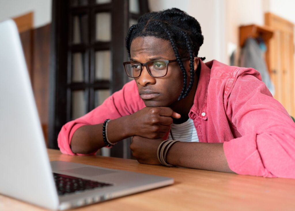 Man looking at laptop using the Pomodoro Technique for overcoming procrastination.