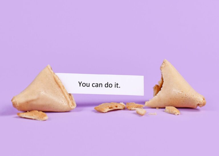 A fortune cookie broken in half that reveals the message, "You can do it."